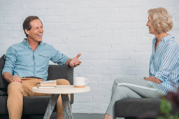 Happy Senior Couple Talking Smiling Each Other While Sitting Together — Stock Photo, Image