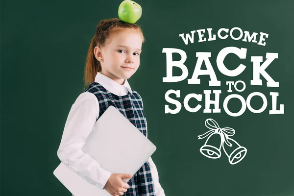 Beautiful Little Schoolgirl Apple Head Holding Laptop Standing Chalkboard Welcome — Stock Photo, Image