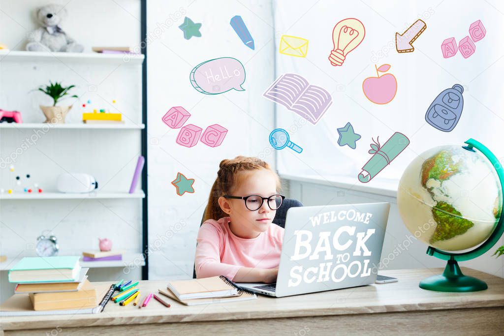 beautiful child in eyeglasses using laptop while studying at desk at home, welcome back to school