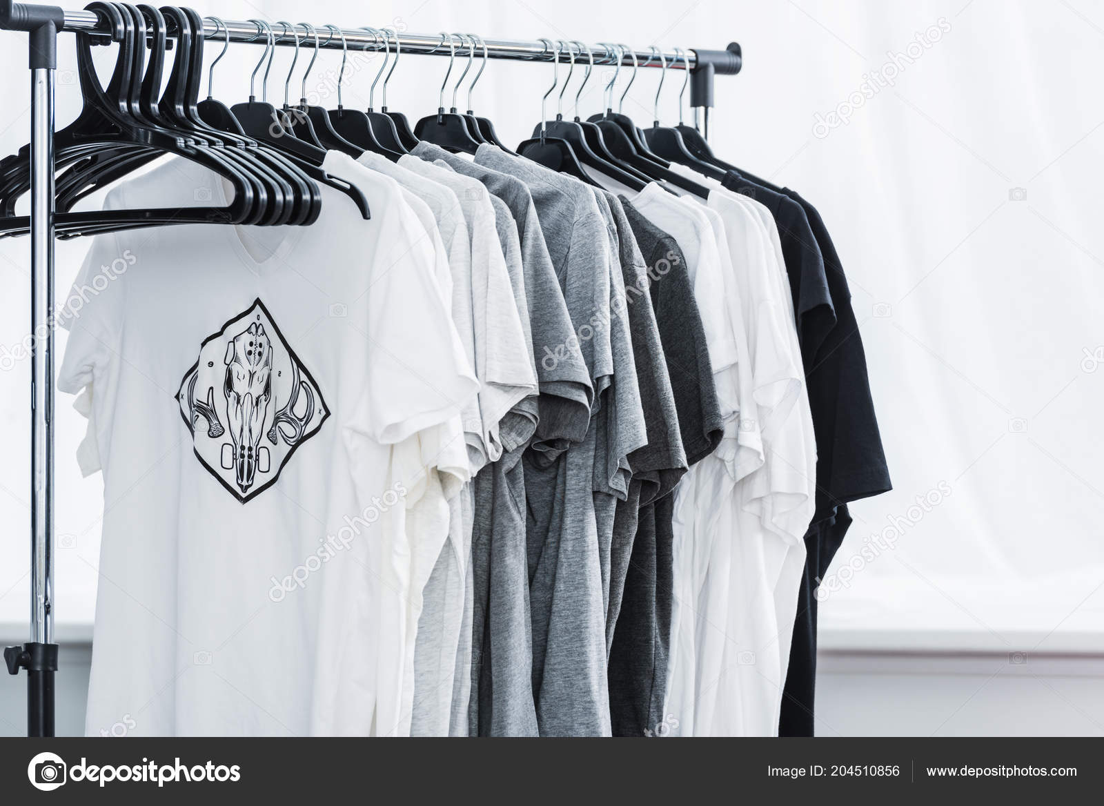 https://st4.depositphotos.com/13193658/20451/i/1600/depositphotos_204510856-stock-photo-selective-focus-shirts-print-hangers.jpg