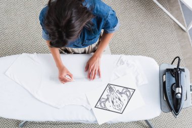 kadın moda tasarımcısı için ölçüm alanı havai görünümü yazdırmak Ütü masası, boş beyaz t-shirt üzerinde