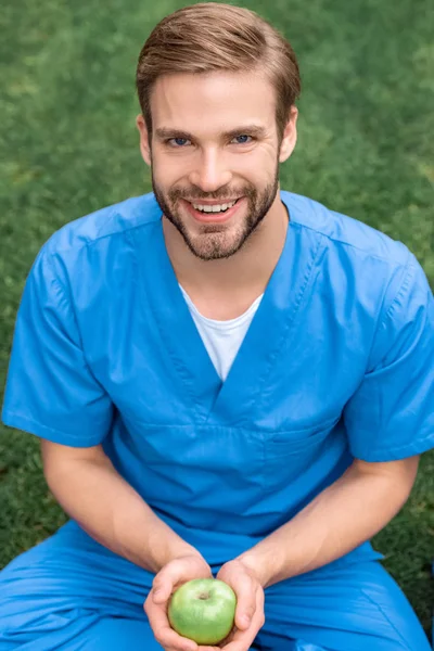 Smiling Handsome Medical Student Holding Apple Hands Looking Camera — Free Stock Photo