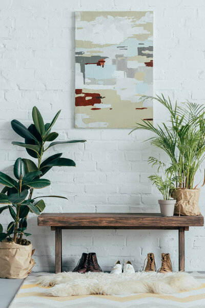 interior of light modern corridor in apartment with potted plants