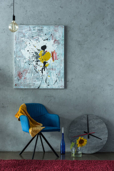 blue chair and modern painting on wall in office