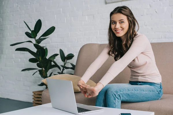 Attractive Young Woman Stretching Hands Smiling Camera While Using Laptop — Stock Photo, Image