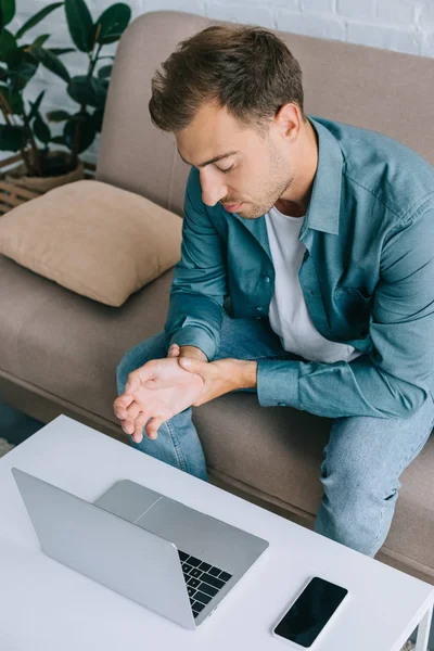 High Angle View Man Having Wrist Pain While Sitting Couch — Stock Photo, Image