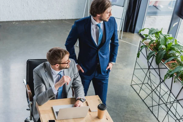 High Angle View Two Young Businessmen Using Laptop While Working — Stock Photo, Image