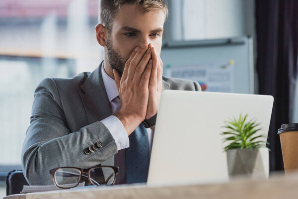 Shocked young businessman using laptop in office — Stock Image Shocked Young Businessman Using Laptop Office Stock Image