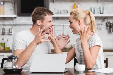 emotional young couple arguing and looking at each other, relationship difficulties concept  clipart