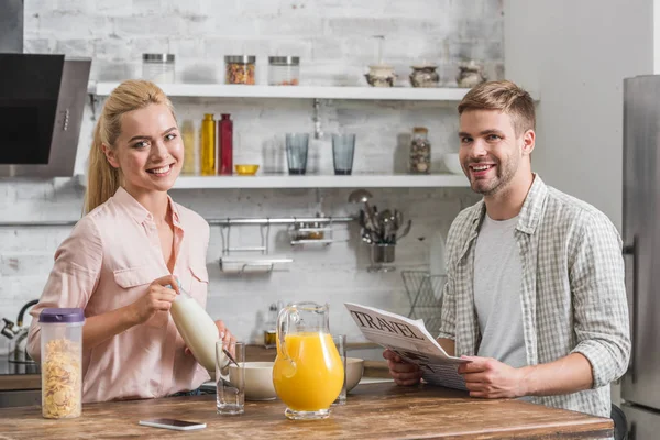 Smiling Boyfriend Holding Newspaper Girlfriend Holding Bottle Milk Breakfast Kitchen — Free Stock Photo