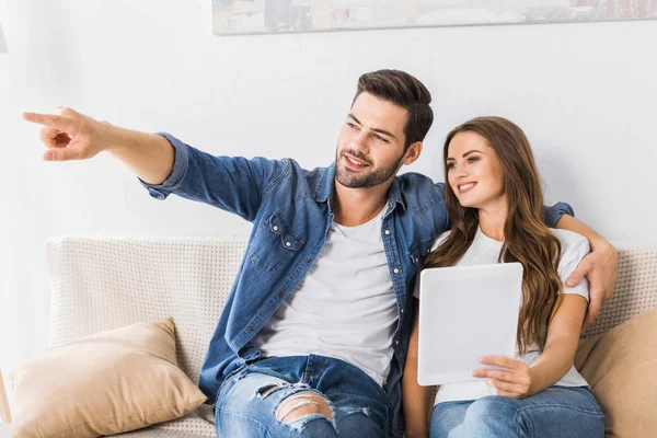 Handsome Young Man Pointing Finger Girlfriend Digital Tablet Couch Home — Stock Photo, Image