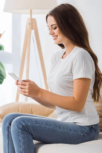 Side View Smiling Young Woman Using Smartphone Sofa Home — Stock Photo, Image