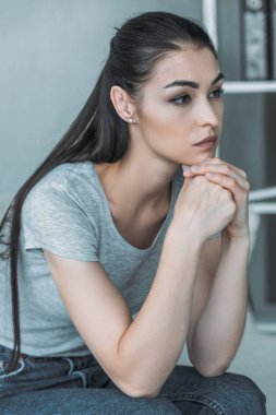 güzel üzgün genç kadın oturuyor ve uzakta ev arıyorum-depresyon 