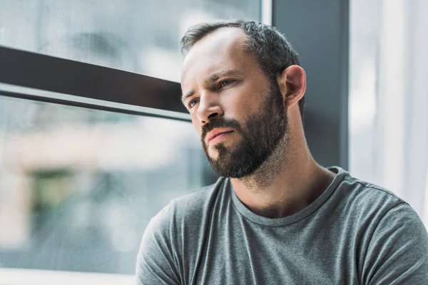 Frustrated Bearded Man Leaning Window Looking Away — Stock Photo, Image