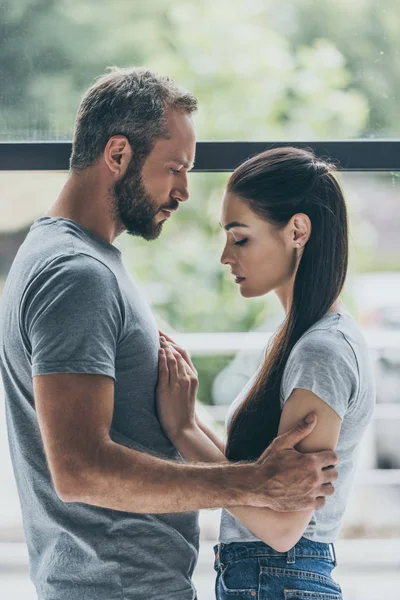 Side View Bearded Man Embracing Sad Young Girlfriend While Standing — Stock Photo, Image