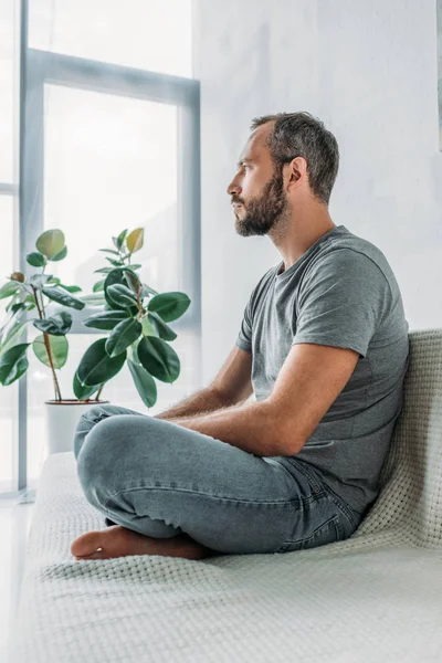 Side View Bearded Frustrated Middle Aged Man Sitting Couch Looking — Stock Photo, Image