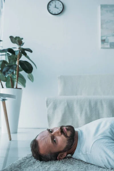 Καταθλιπτική Γενειοφόρος Μέσης Ηλικίας Άνθρωπος Ξαπλωμένος Στο Χαλί Και Βλέπουν — Φωτογραφία Αρχείου