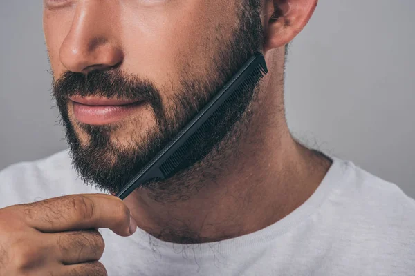 Cropped Shot Bearded Man Combing Beard Comb Isolated Grey — Stock Photo, Image