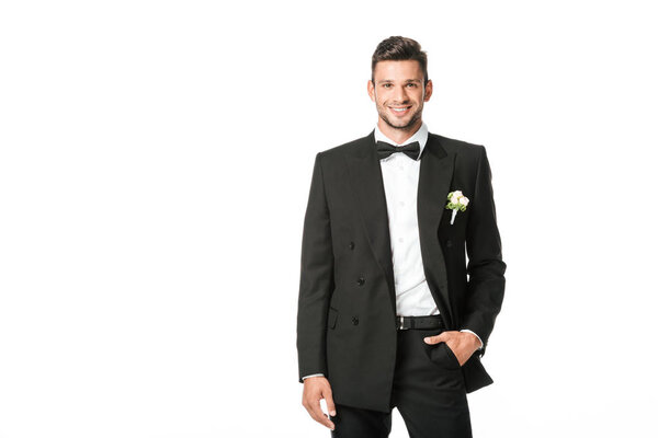 happy groom in black suit looking at camera isolated on white