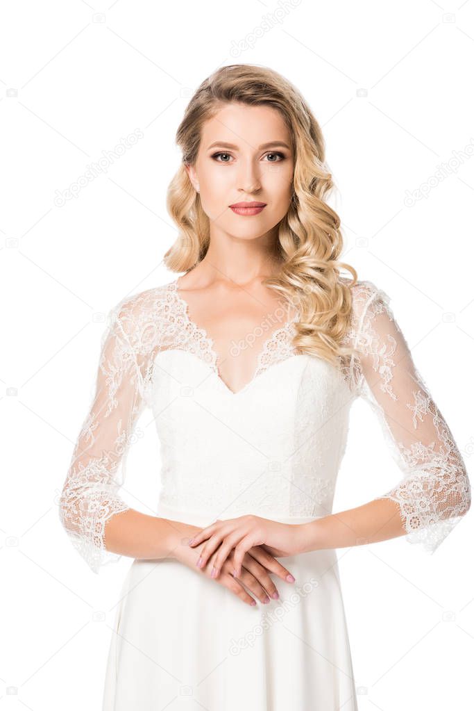 close-up portrait of young bride in wedding dress looking at camera isolated on white