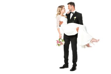 happy young groom carrying his bride isolated on white clipart