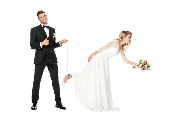 Happy Groom Holding Chain Tied Brides Leg Showing Thumb Isolated — Stock Photo, Image