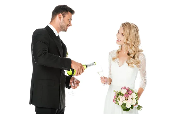 Groom Pouring Champagne While Bride Holding Glass Isolated White — Free Stock Photo