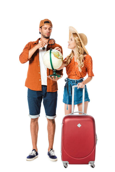 couple standing with globe and travel bag isolated on white