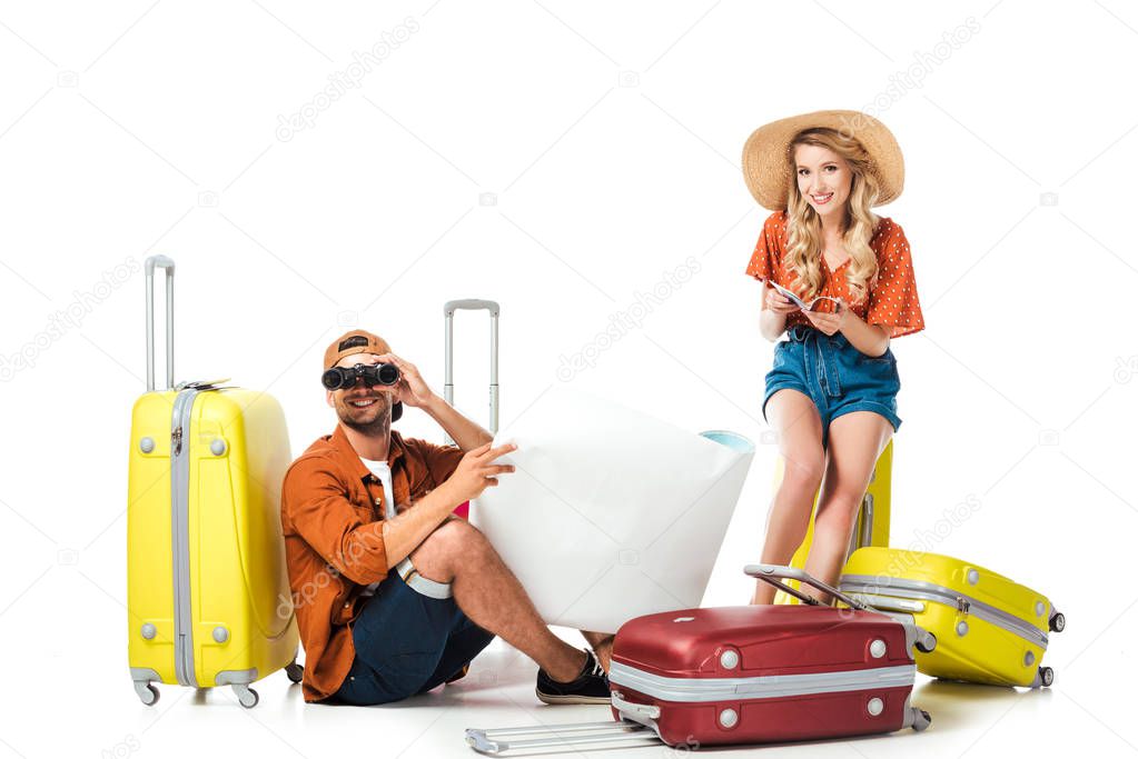 newlywed couple with suitcases, binoculars and map isolated on white