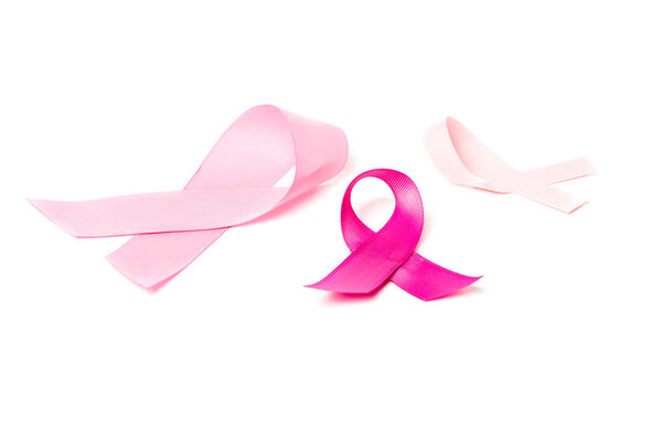 close-up view of pink breast cancer awareness ribbons isolated on white