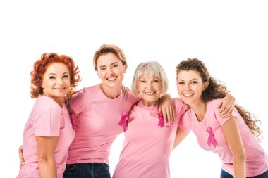 cheerful women in pink t-shirts with breast cancer awareness ribbons smiling at camera isolated on white clipart