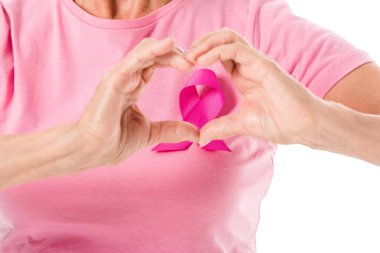 cropped shot of senior woman in pink t-shirt with breast cancer awareness ribbon showing hand heart symbol isolated on white clipart