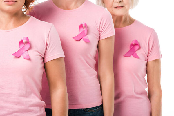 cropped shot of women with pink ribbons standing together isolated on white, breast cancer awareness concept 