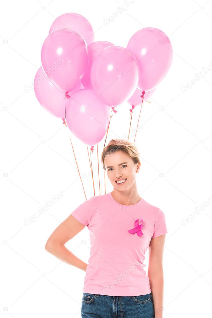 middle aged woman holding pink balloons and smiling at camera isolated on white, breast cancer concept  