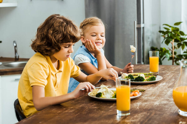 children eating healthy vegetables and drinking juice together