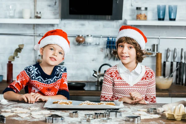 Cute Happy Kids Santa Hats Preparing Ginger Cookies Smiling Camera — Stock Photo, Image