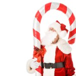 Santa claus with giant candy cane looking up isolated on white