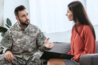 soldier in uniform with ptsd talking to psychiatrist at therapy session clipart