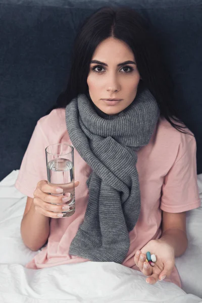 Sick Young Woman Holding Pills Glass Water While Lying Bed — Free Stock Photo