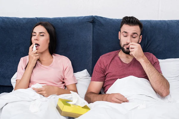 Sick Couple Using Cough Nose Spray While Sitting Bed — Stock Photo, Image