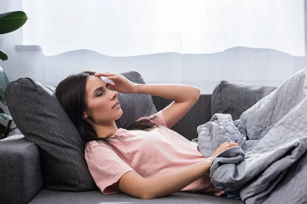 Young Woman Suffering Headache While Lying Couch — Free Stock Photo