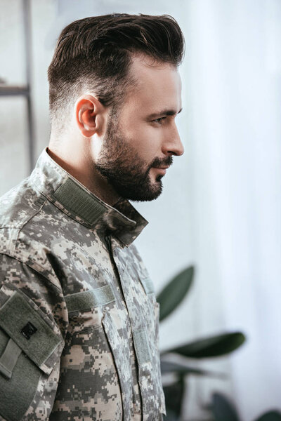 side view of army man in military uniform at home