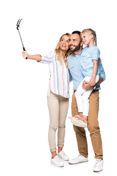 smiling family taking selfie on smartphone isolated on white