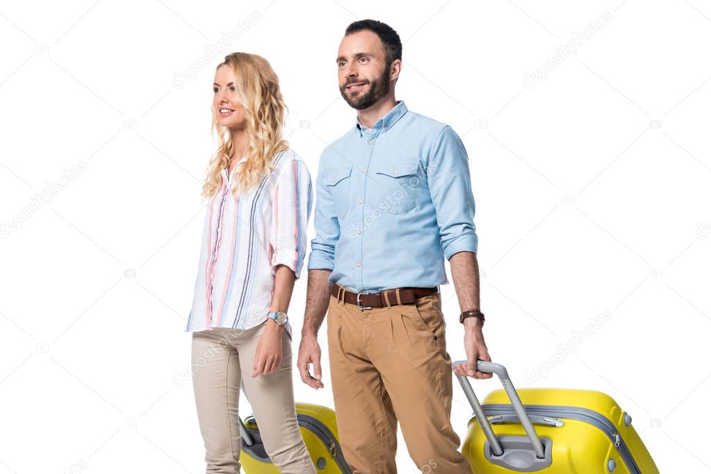 happy couple with yellow baggage isolated on white