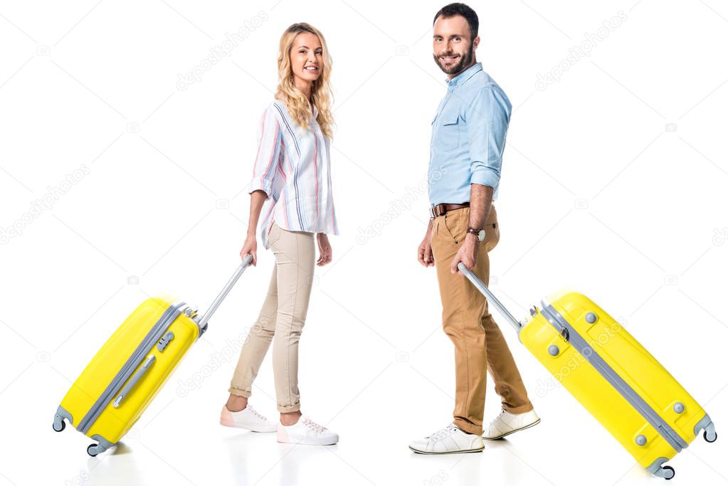 happy couple with yellow travel bags isolated on white