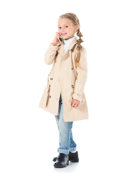 Happy Adorable Kid Beige Coat Talking Smartphone Isolated White — Free Stock Photo