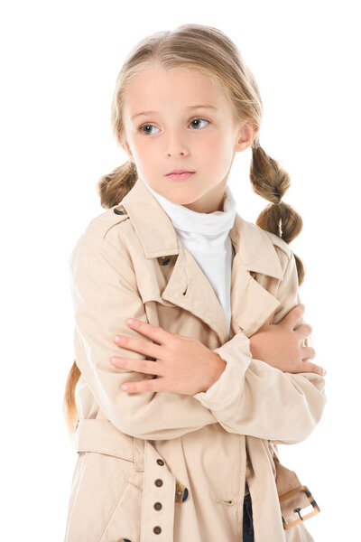 adorable kid posing in trendy beige coat, isolated on white