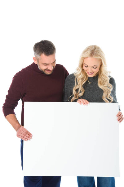 couple in autumn outfit holding empty board, isolated on white