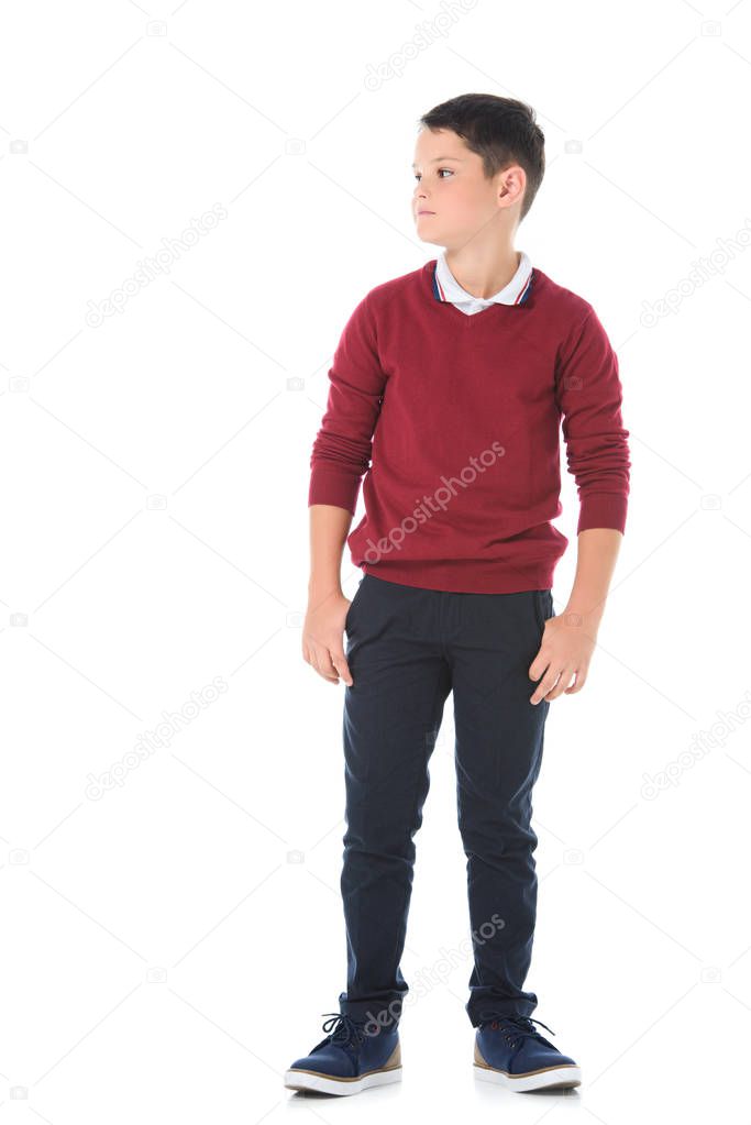 preteen serious boy posing in casual clothes and looking away isolated on white