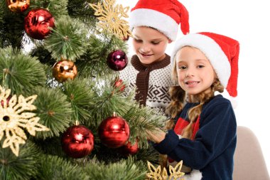 mutlu kardeşler Noel Baba şapkası topları ile Noel ağacı süsleme